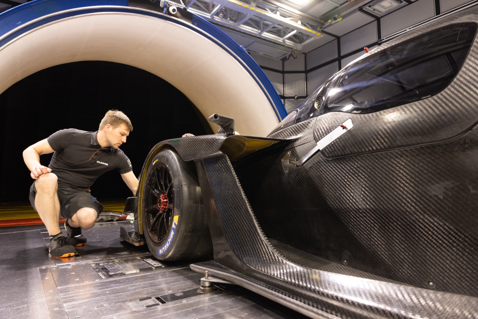 Engineer studying the rear suspension and floor geometry at the Pininfarina tunnel