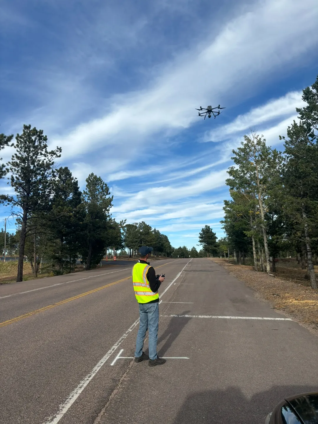 Drone operator flying photogrammetry capture over the Pikes Peak road